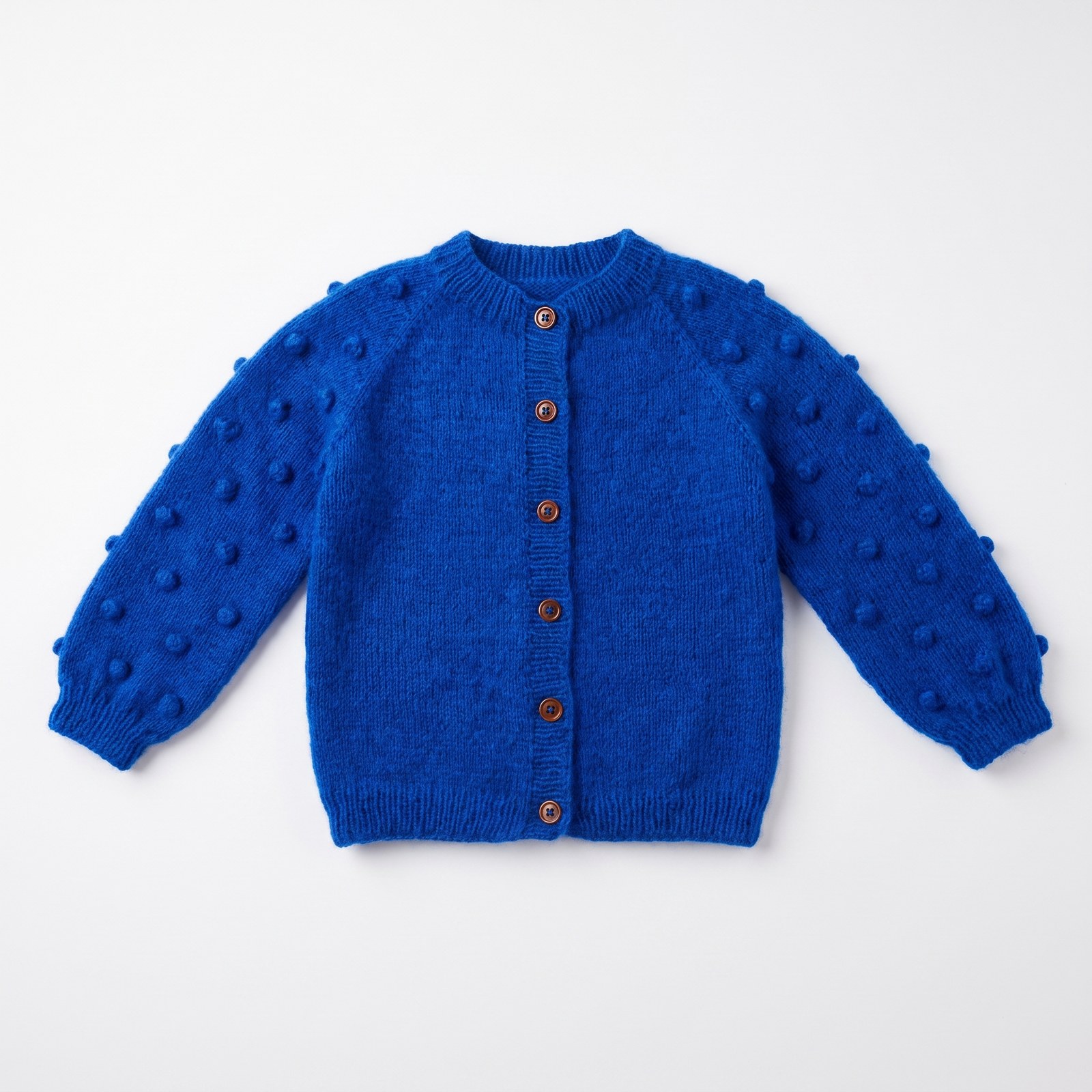 Cobalt blue mohair hand-knit baby cardigan with all-over bobble texture and walnut buttons