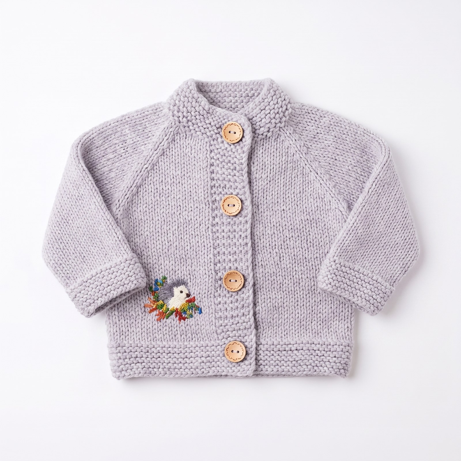 Dove grey hand-knit baby set with hooded cardigan, bonnet and mittens embroidered with a hedgehog